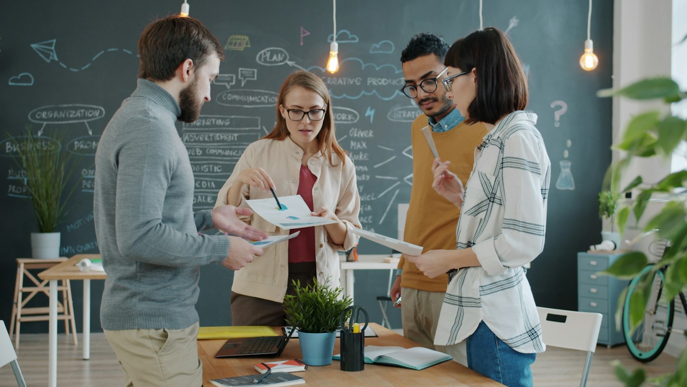 Diverse team reviewing charts together